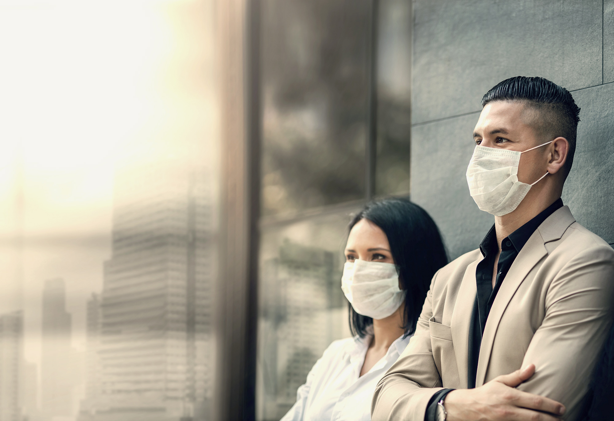 two people standing outside with pandemic masks on