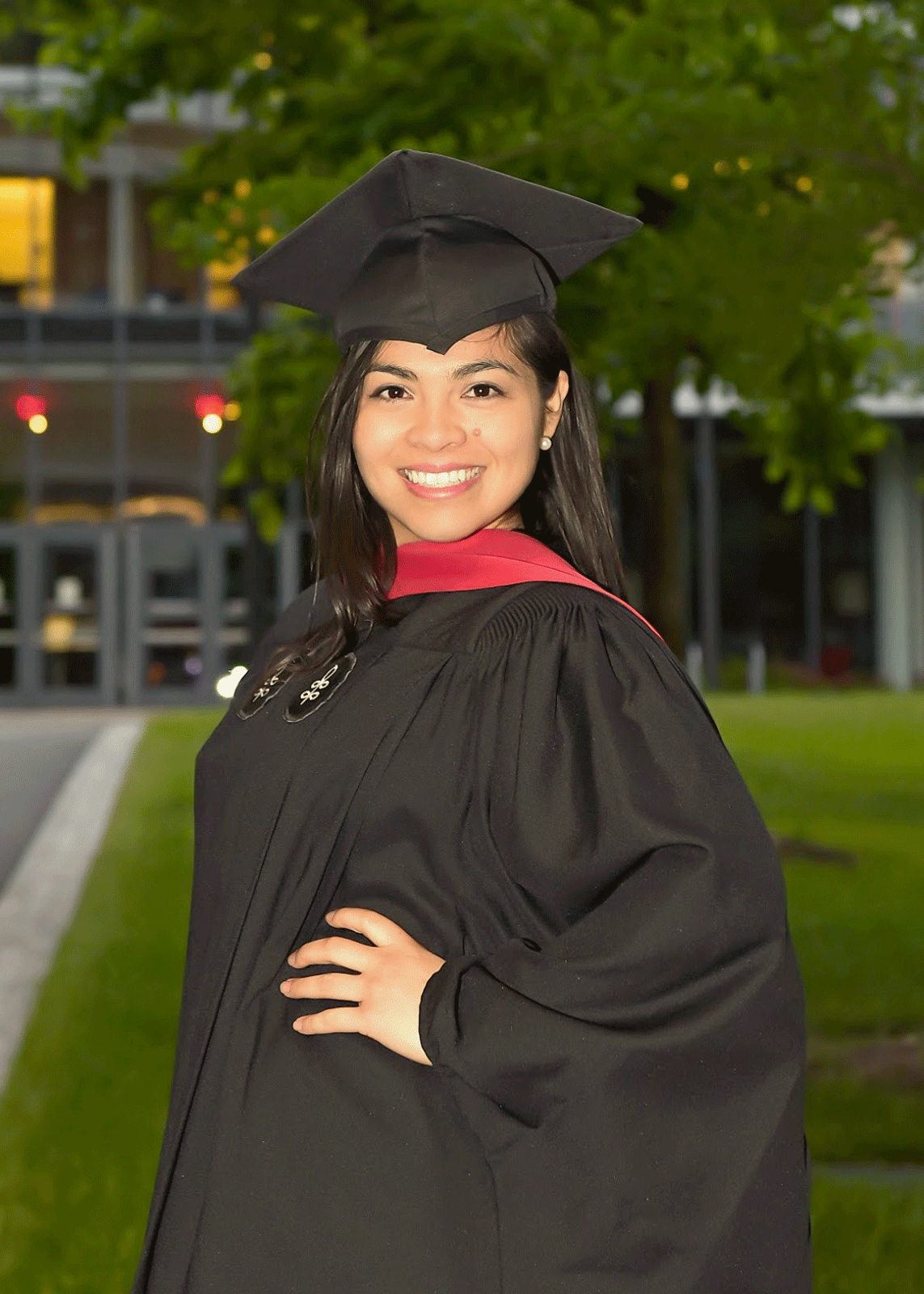 Lizbeth Sanchez Arce dressed in full Harvard regalia, including a cap and gown.