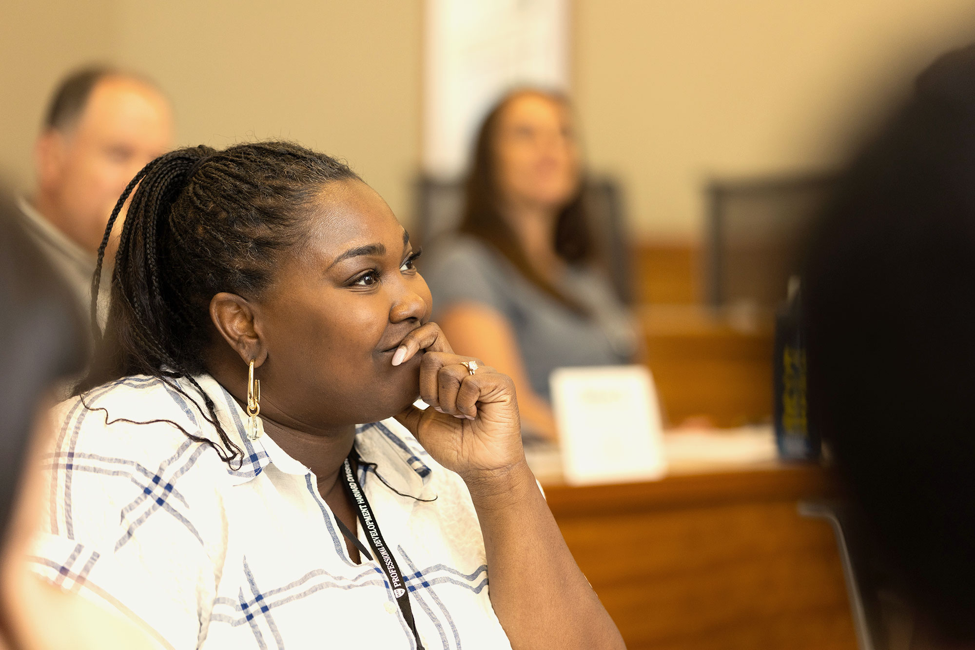 A woman listens attentively in a PDP classroom.