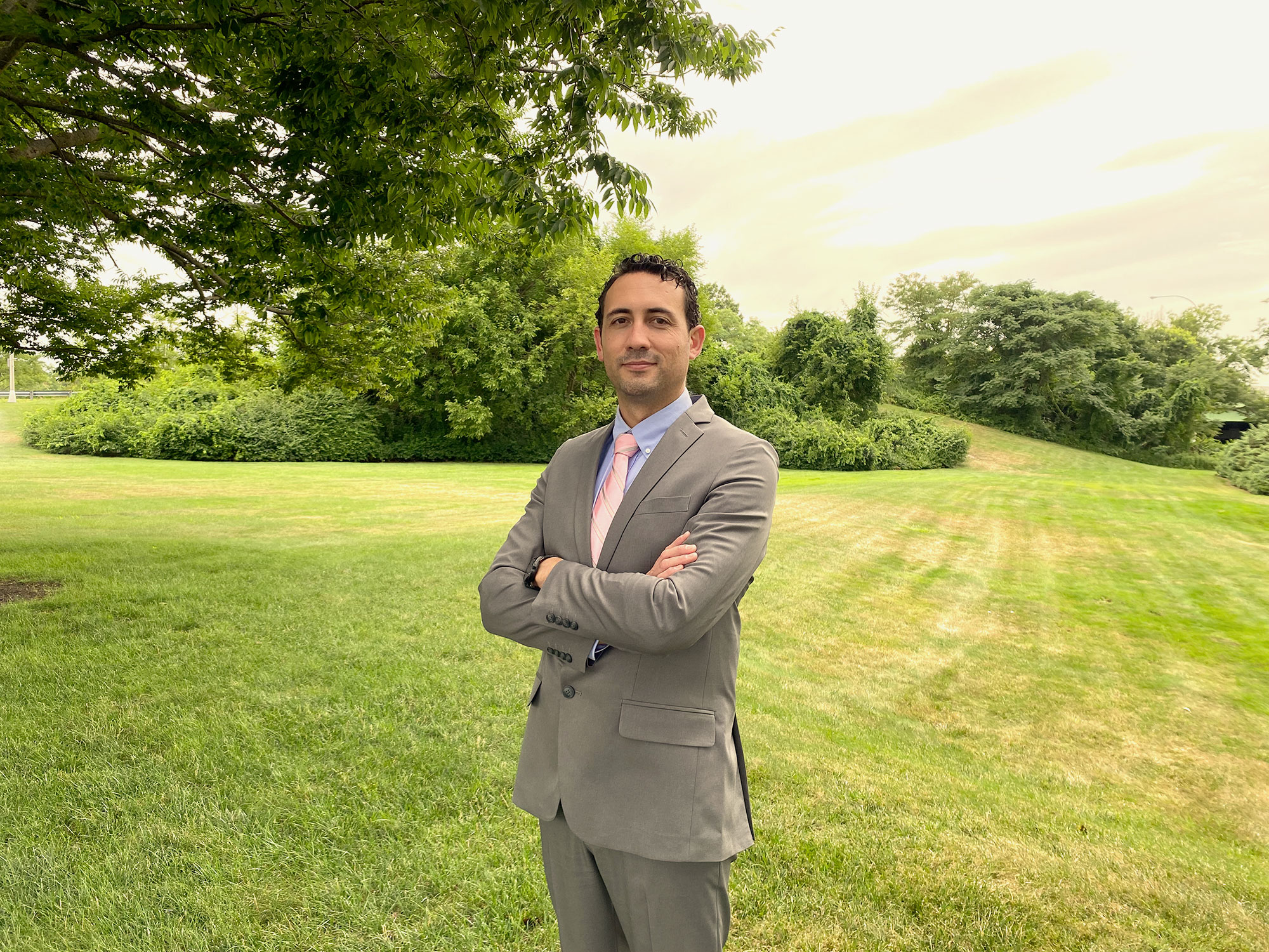 Osmond K stands in a green grassy field.