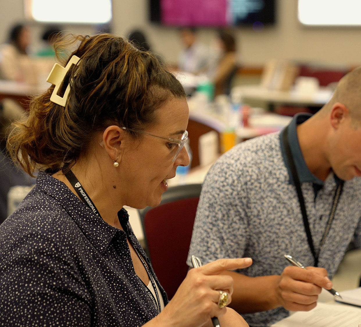 Two professional development students work together in a classroom.