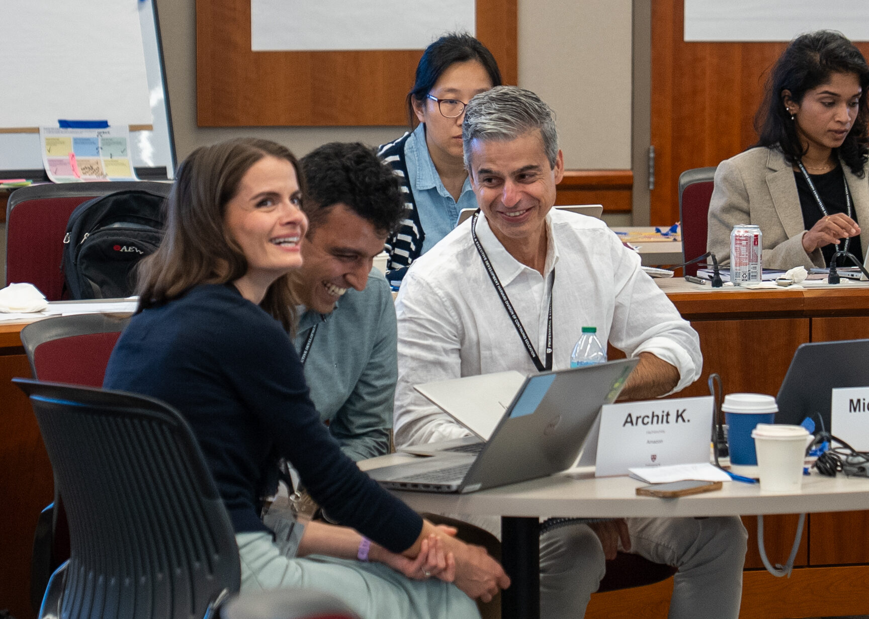 A group of Harvard Professional & Executive Development participants work together in class.